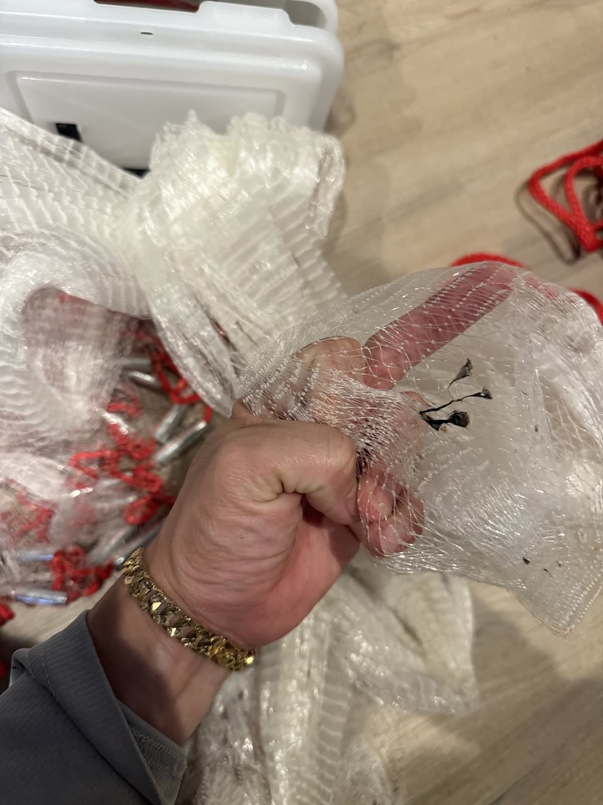 A customer grips their Classic Series cast net by the cooler